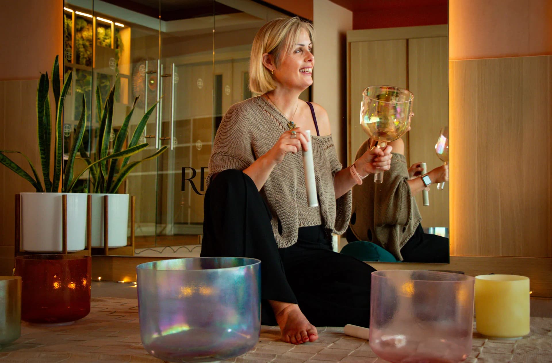 Complete Health Clinic practitioner playing crystal singing bowls in the retreat space at The Lowry Hotel, Manchester