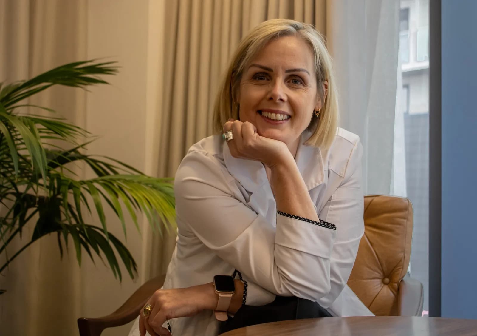 Helen O’Brien, ARCH-registered colon hydrotherapist, smiling at a table at Complete Health Clinic, Manchester