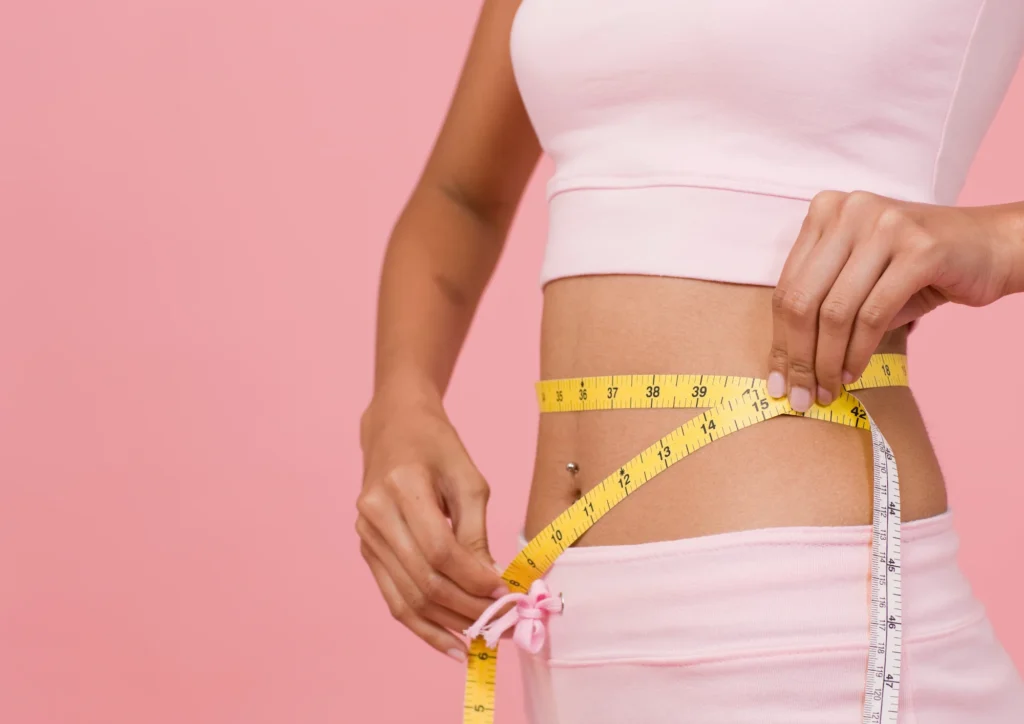 Women measuring her waist after taking Ozempic
